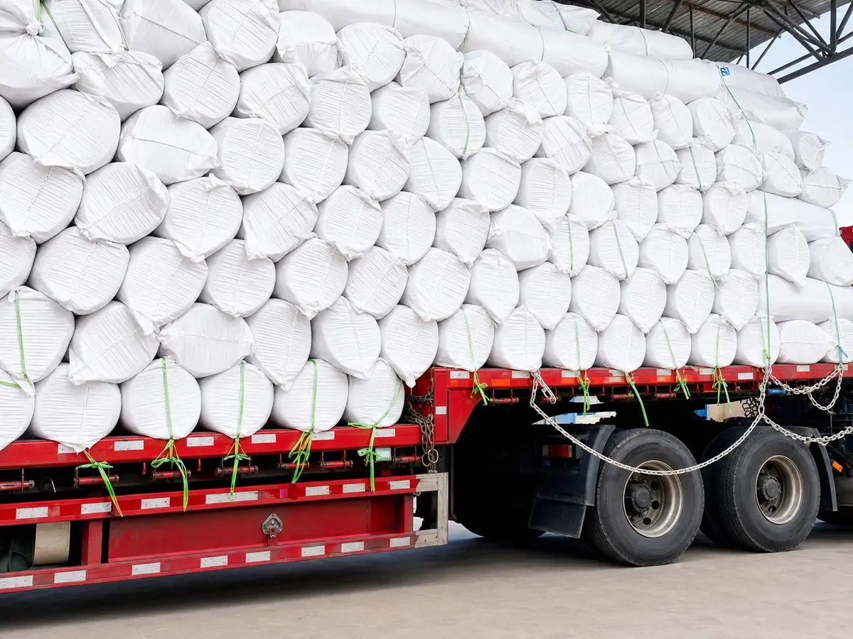 Stacked packed ceramic fiber blanket rolls loaded on flatbed truck ready for logistics and overseas transportation