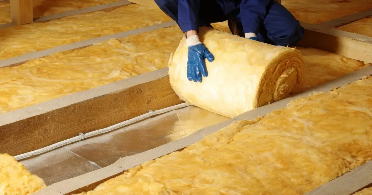 glass‑wool‑blanket‑roll‑installation‑attic‑wood‑joist